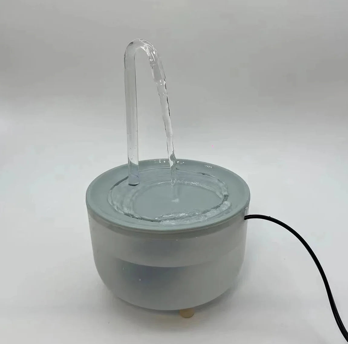 Paw Care USA automatic pet water fountain with clear water flow and sleek round design