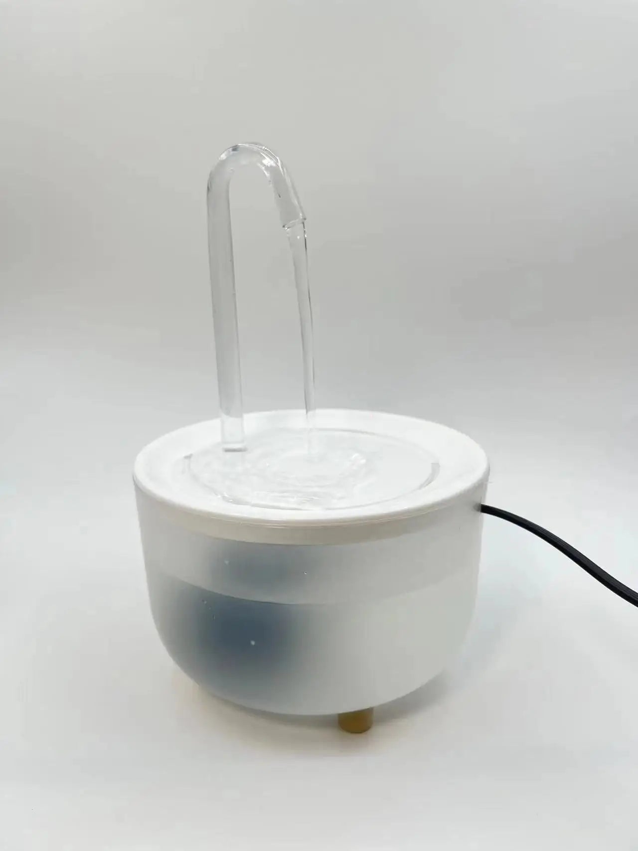 Paw Care USA automatic pet water fountain with clear spout and white base for pets