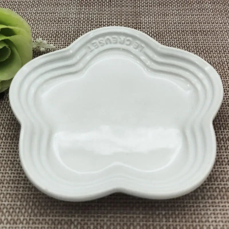 Paw Care USA white whisker friendly cat bowl with paw-shaped design on woven surface