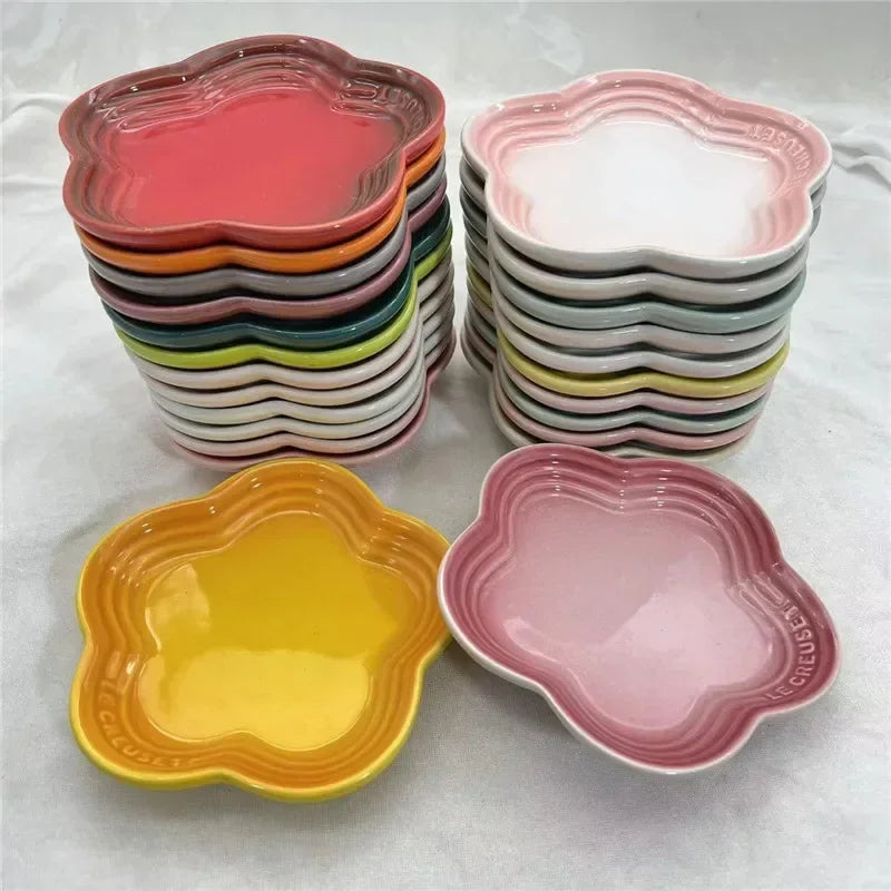 Stack of colorful Paw Care USA whisker friendly cat bowls in flower shapes for comfortable pet feeding