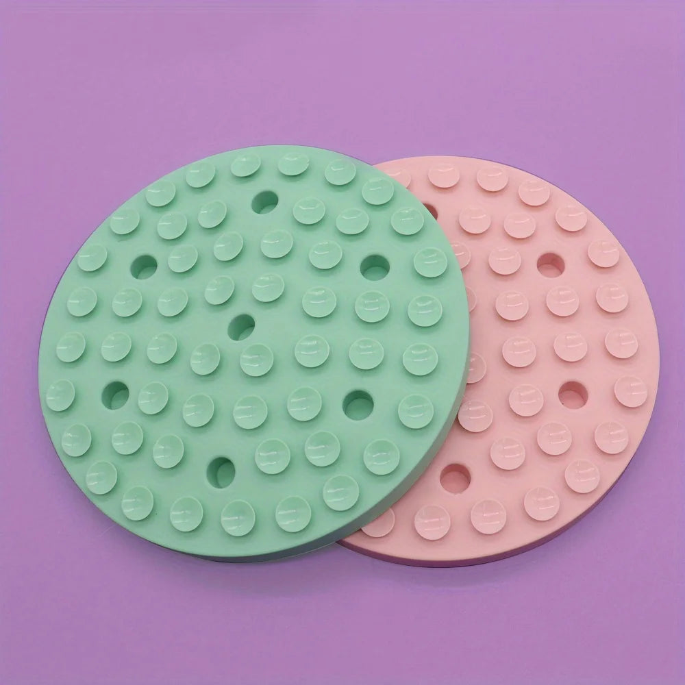 Round green and pink pet slow feeding bowl for dogs with raised bumps to slow eating