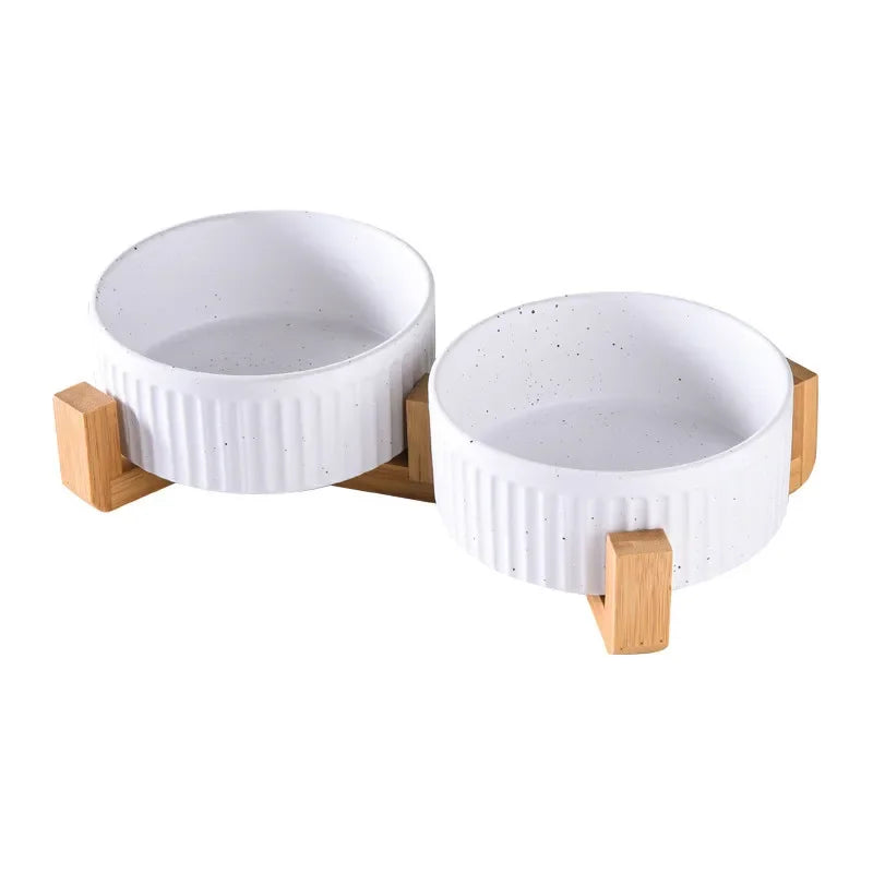 Paw Care USA premium ceramic pet food and water bowls with white speckled design on wooden stand