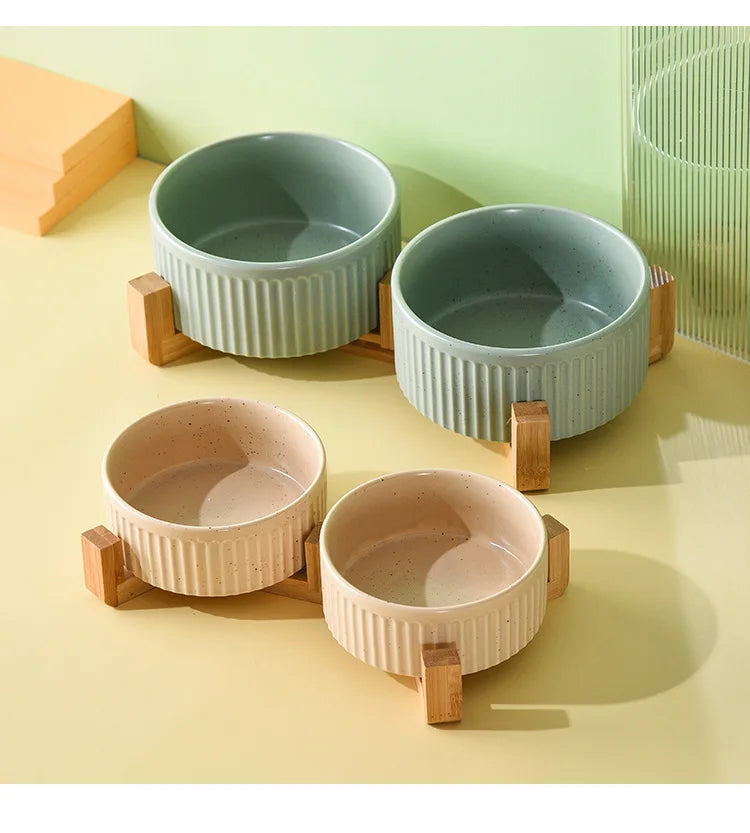 Set of premium ceramic pet food and water bowls in green and beige with wooden stands