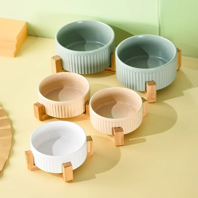 Set of premium ceramic pet food and water bowls in pastel colors with wooden stands by Paw Care USA